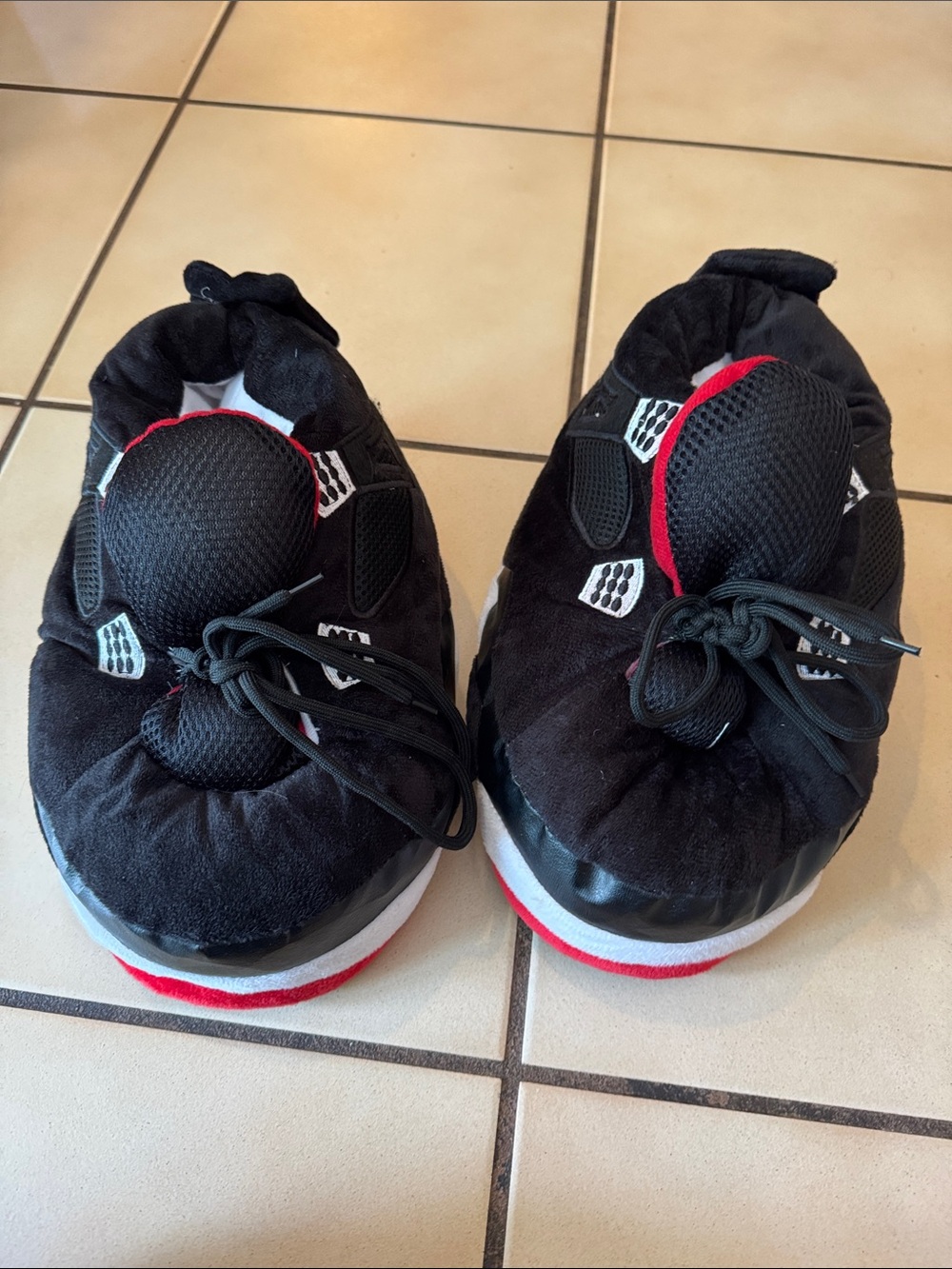 Air Jordan Kids Black and Red fuzzy slippers.